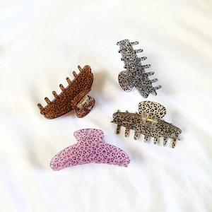 Set of four large leopard print hair claws in brown, gray, green and pink colors