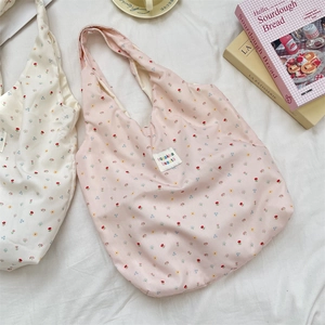 Close-up of floral pattern cotton tote bags with sozakka beaute label on white fabric