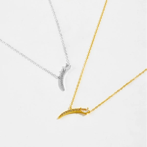 Detail of moon pendant necklaces in gold and silver with shimmering pavé set zirconia