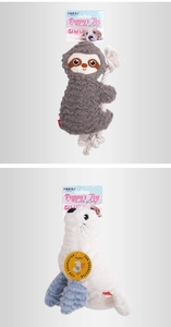 Detail view of plush dog toys including a grey sloth with bite rope and a white sea lion toy
