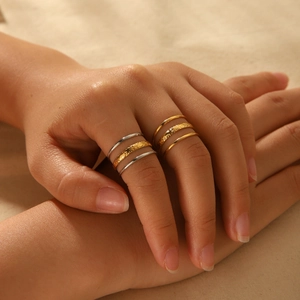 Three-layer 18K gold and silver stainless steel rings with smooth and hammered textures
