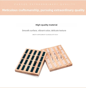 Detail of wooden ring display trays with green and beige velvet slots for jewelry storage