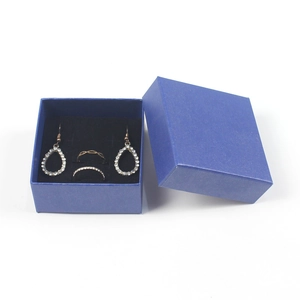Square blue jewelry gift box set with crystal drop earrings and shimmering silver rings