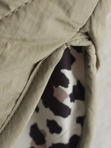 Detailed macro view of khaki fabric texture paired with stylish leopard print lining