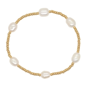 Elegant baroque pearl bracelet with golden TOHO beads on a minimalist elastic cord