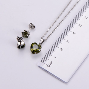 Macro shot showing dimensions of green heart zircon pendant and matching stud earrings