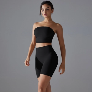 Close-up of black two-piece yoga set featuring a tube top and high-waist sports shorts