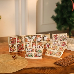 Detail of 12pcs wooden Christmas ornaments including gnomes and gingerbread man in a box