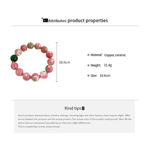 Detail view of 18.6cm copper and ceramic bead bracelet with pink and green floral patterns