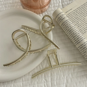 Elegant gold metal hair claw clips in stylish crisscross and hollow square designs
