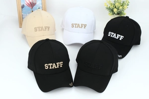 Detail view of five baseball caps featuring STAFF embroidery in various color combinations