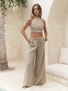 Detailed view of women's linen-style halter crop top and drawstring wide leg trousers