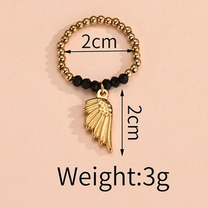 Detail of elastic beaded ring with golden wing pendant showing 2cm diameter and 3g weight