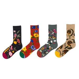 Detailed flat lay of four cotton crew socks in black, red, grey, and beige with floral patterns