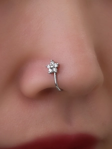 Macro shot of silver five-petal flower nose clip with micro-set zircon stones