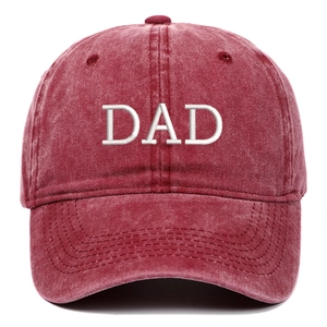 Close-up of DAD embroidery on red washed cotton baseball cap with vintage finish