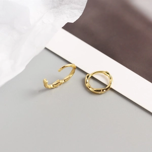 Detailed macro shot of S925 sterling silver twisted hoop earrings with gold plating