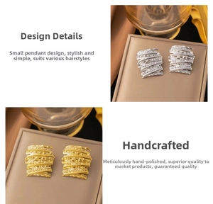 Detailed view of handmade irregular hammered texture on 18k gold and silver stud earrings