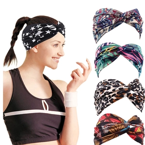 Detail view of five bohemian elastic headbands featuring paisley, floral, and leopard patterns