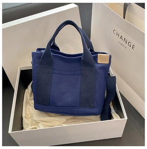 Navy blue canvas tote bag in gift box with shoulder strap and leather tag detail