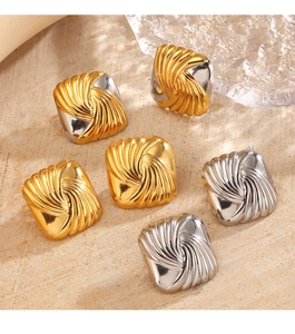 Macro shot of geometric square metal earrings with swirl texture in gold and silver finish