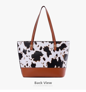 Back view of a cow print tote bag with brown leather details and large capacity