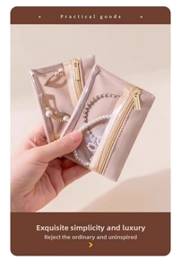 Detail of pink velvet jewelry pouch with clear window and gold metal zipper hardware