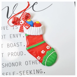 Close-up of red polymer clay Christmas stocking ornament with 3D bow details