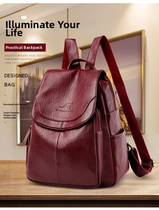 Detail of burgundy textured leather backpack featuring an embossed kangaroo logo