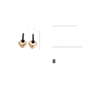 Detail view of geometric square drop earrings with black studs and alloy specifications