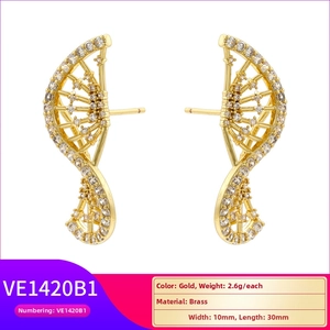 Macro shot of gold brass butterfly wing earrings with white zircon pave setting