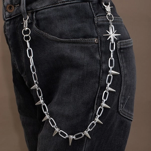Detail of silver metal wallet chain featuring sharp spikes and octagonal star pendants