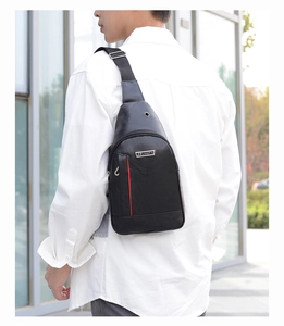 Detail view of black PU leather crossbody bag featuring a vertical red stripe for men
