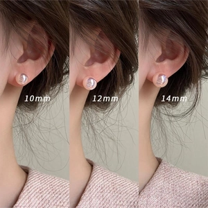 Pink mermaid pearl stud earrings shown in three sizes 10mm 12mm and 14mm on ear