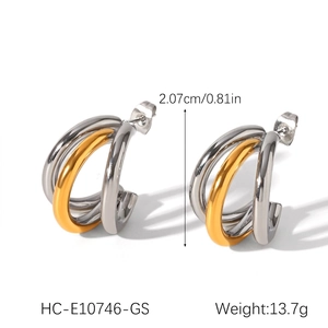 Detail shot of two-tone gold and silver triple-layered C-shaped stud earrings