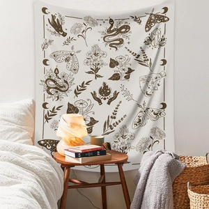 Detail of bohemian tapestry featuring mystic snake and crescent moon in a cozy bedroom