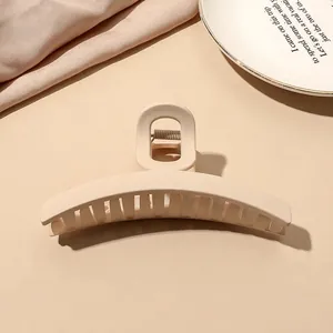 Detailed view of beige matte shark hair claw clip with sturdy metal spring mechanism