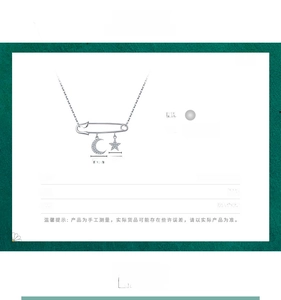 Detail view of S925 silver safety pin necklace with star and moon zircon charms
