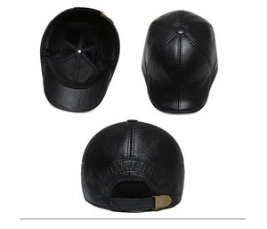 Detail of adjustable metal buckle and embossed lettering on black leather cap