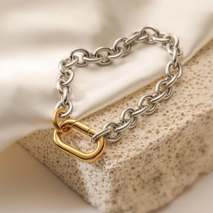 Two-tone silver and 18K gold plated stainless steel chain bracelet on stone base
