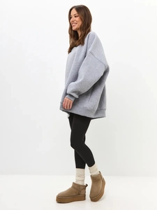 Full body side view of a gray oversized fleece sweatshirt with dropped shoulders