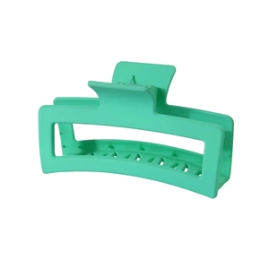 Detail shot of a matte mint green rectangle hair claw clip with internal metal spring