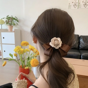 Brown satin bow hair clip with cream camellia flower accessory for women's hairstyle