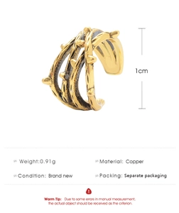 Detail view of a 1cm golden copper ear cuff with a branched crossover design and dimensions
