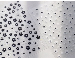 Macro detail of TL-317 nail art stickers with black and white flowers and pearls