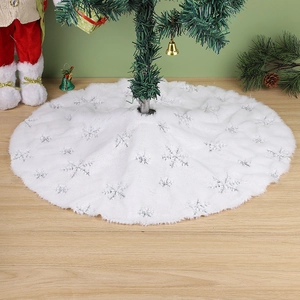 Detail of white plush Christmas tree skirt featuring silver sequin snowflake patterns