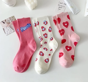 Detailed view of pink floral and heart pattern cotton socks with ribbed non-slip cuffs