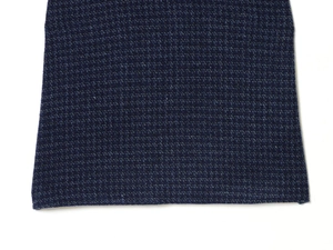 Gros plan détaillé du tissu en tweed bleu foncé et des finitions de l'ourlet de la robe