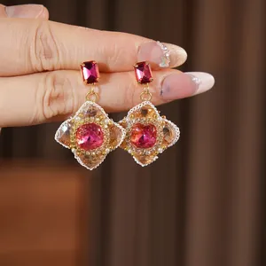 Vintage gold earrings with red crystal and pearls in ornate floral palace style