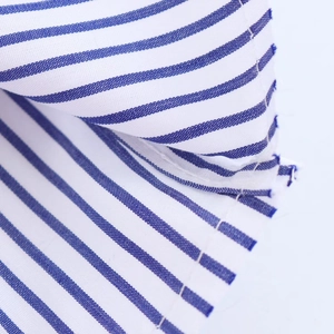 Close-up of white and blue striped cotton fabric for casual collared commute shirts